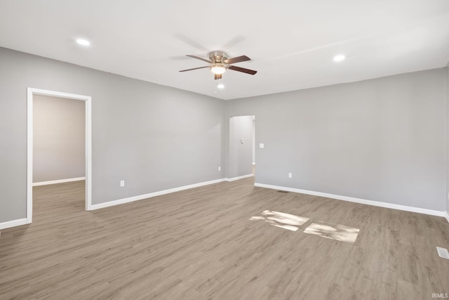 empty room with light hardwood / wood-style floors and ceiling fan