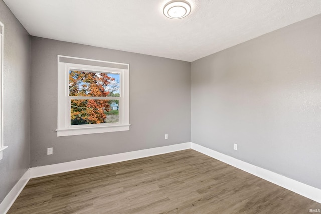 spare room featuring dark hardwood / wood-style flooring