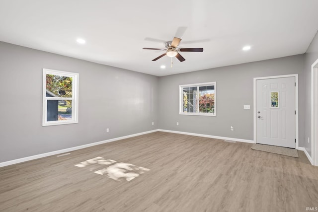 interior space featuring ceiling fan, a healthy amount of sunlight, and light wood-type flooring