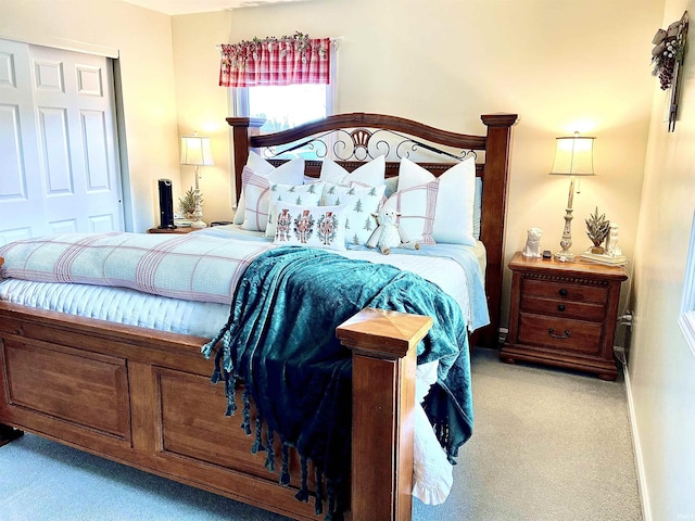 bedroom featuring a closet and light colored carpet