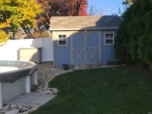 view of outbuilding featuring a lawn