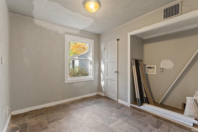 spare room featuring a textured ceiling