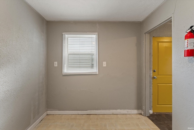 spare room featuring a textured ceiling