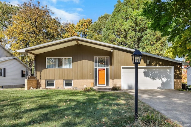 view of front of property with a front yard and a garage