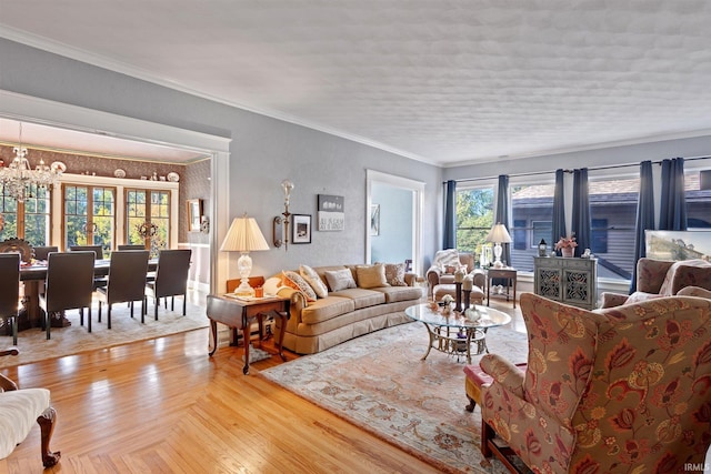 living room featuring an inviting chandelier, crown molding, and light wood-type flooring