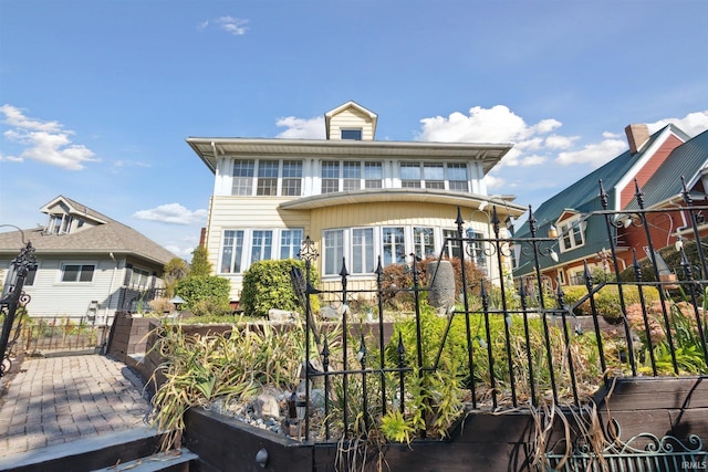 rear view of property with fence