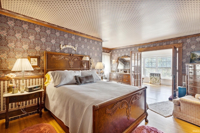 bedroom with ornamental molding and hardwood / wood-style floors