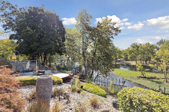 view of yard with fence and a water view