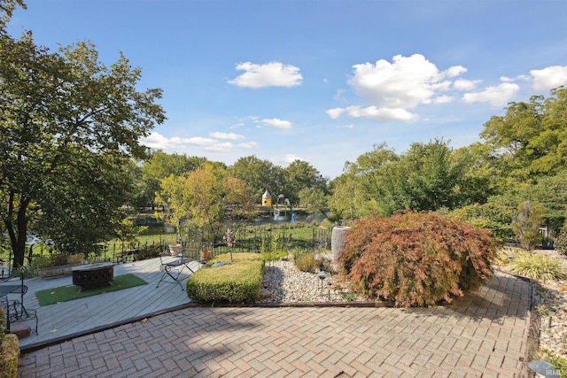 view of patio with a fire pit and fence