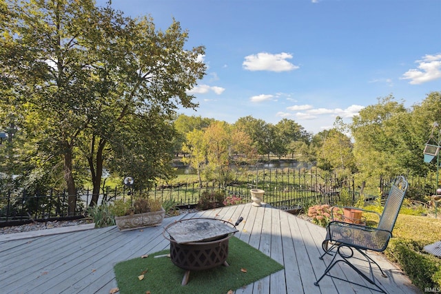 wooden terrace featuring a fire pit