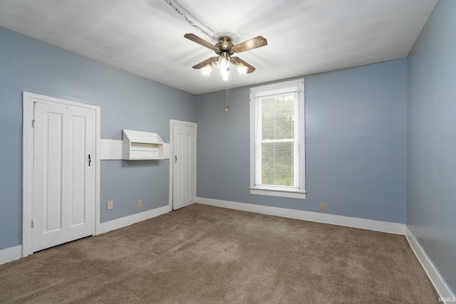 unfurnished bedroom featuring ceiling fan and carpet floors