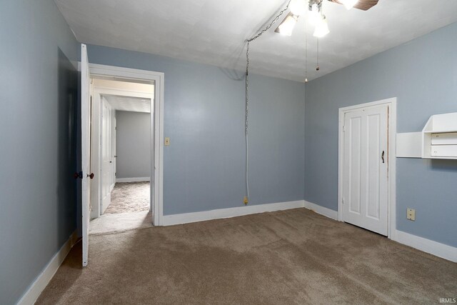 spare room with light colored carpet and ceiling fan