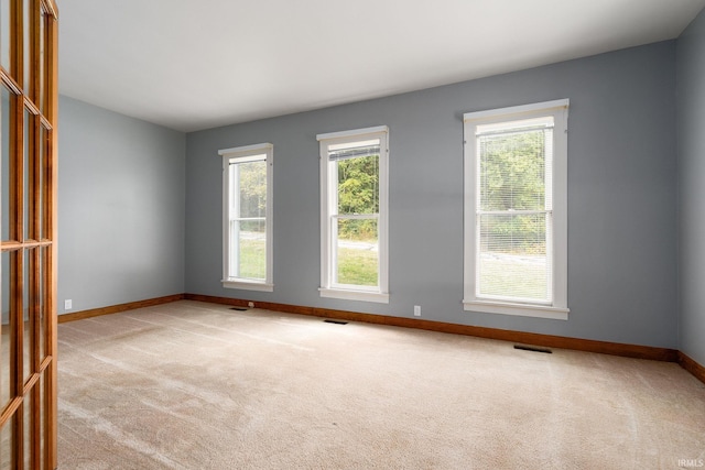 empty room featuring light carpet