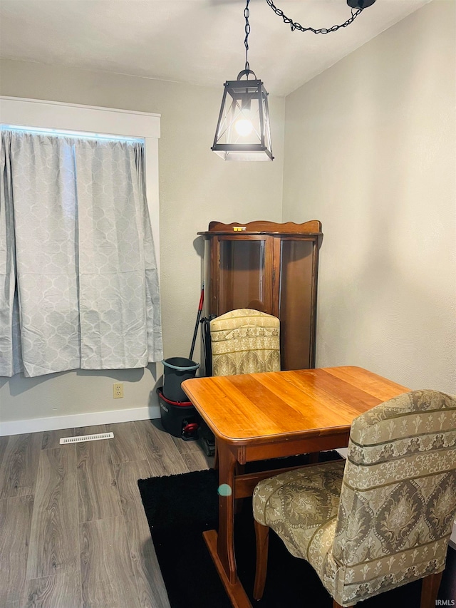 dining space with hardwood / wood-style floors