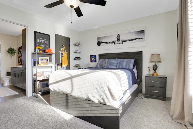 bedroom with connected bathroom, ceiling fan, and carpet flooring