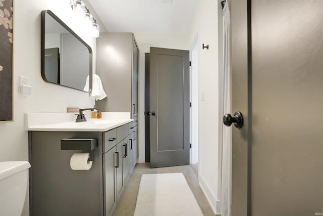 bathroom featuring vanity, toilet, and tile patterned flooring