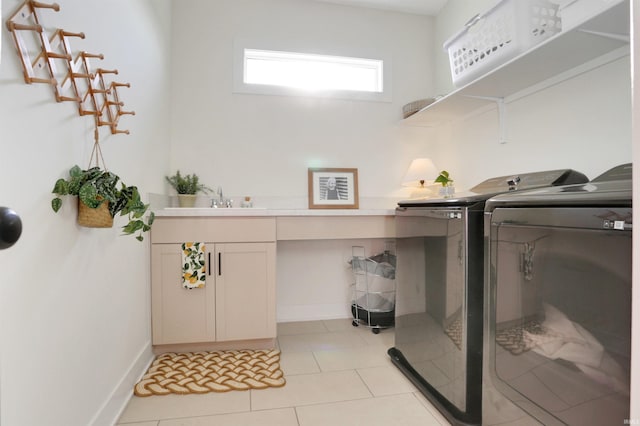 laundry room with sink, light tile patterned flooring, and separate washer and dryer