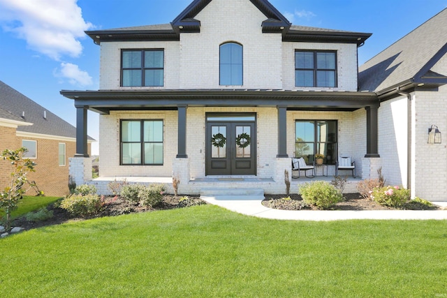 view of front facade with covered porch and a front lawn