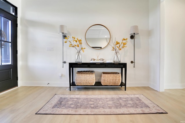 entryway with hardwood / wood-style flooring