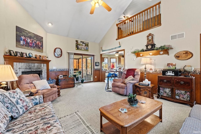 carpeted living room featuring high vaulted ceiling, a fireplace, and ceiling fan