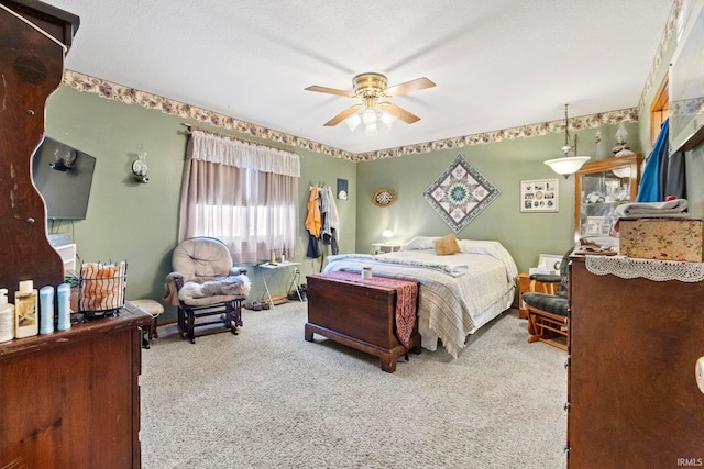 carpeted bedroom with a textured ceiling and ceiling fan