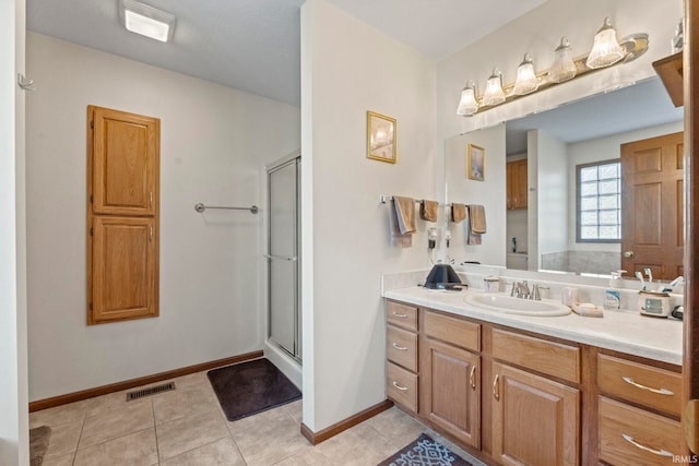 bathroom with vanity, tile patterned floors, and walk in shower