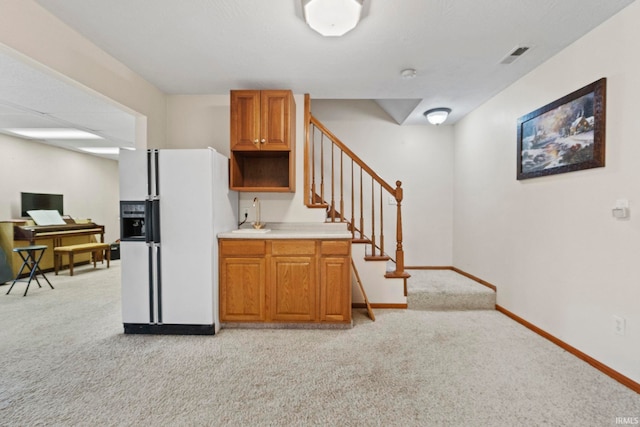 kitchen featuring light carpet and white refrigerator with ice dispenser