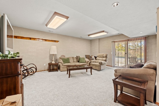 carpeted living room with a textured ceiling