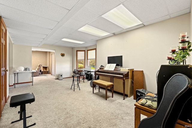 home office with a paneled ceiling and light colored carpet