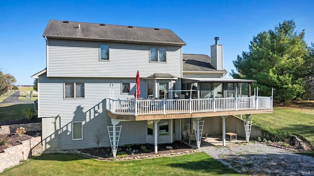 rear view of house featuring a yard, a patio area, and a wooden deck