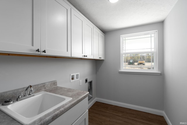 washroom with hookup for a washing machine, sink, hookup for an electric dryer, dark hardwood / wood-style flooring, and cabinets