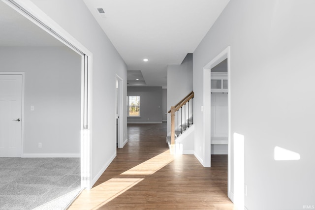 corridor with hardwood / wood-style floors