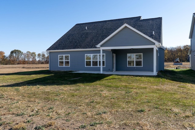 back of property featuring a yard