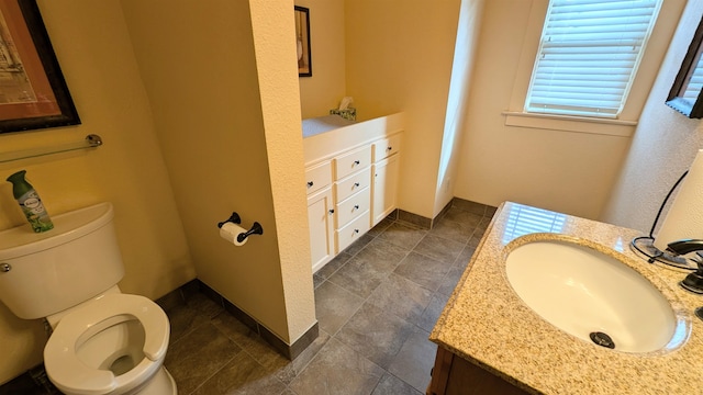 bathroom featuring toilet and vanity