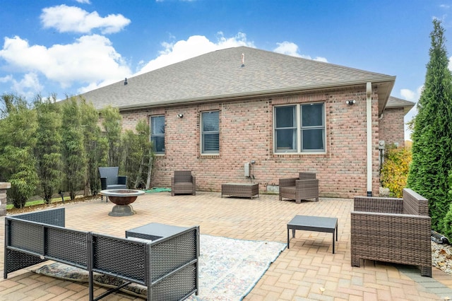 rear view of property with an outdoor fire pit and a patio area