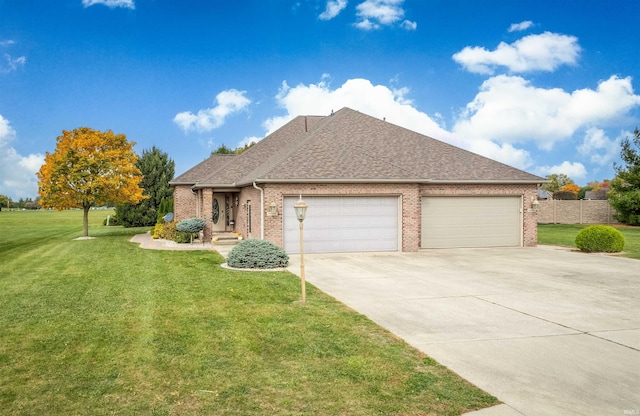 view of front of home featuring a front yard and a garage