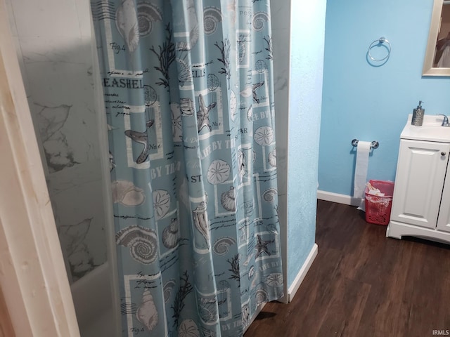 bathroom with vanity, wood-type flooring, and walk in shower