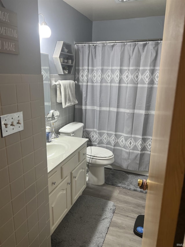 4116 N Lancaster Dr, Muncie, IN 47304 - bathroom with tile walls, curtained shower, wood finished floors, vanity, and toilet