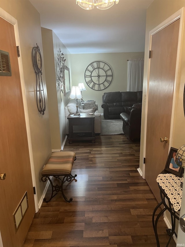 4116 N Lancaster Dr, Muncie, IN 47304 - corridor with an inviting chandelier, baseboards, wood finished floors, and visible vents