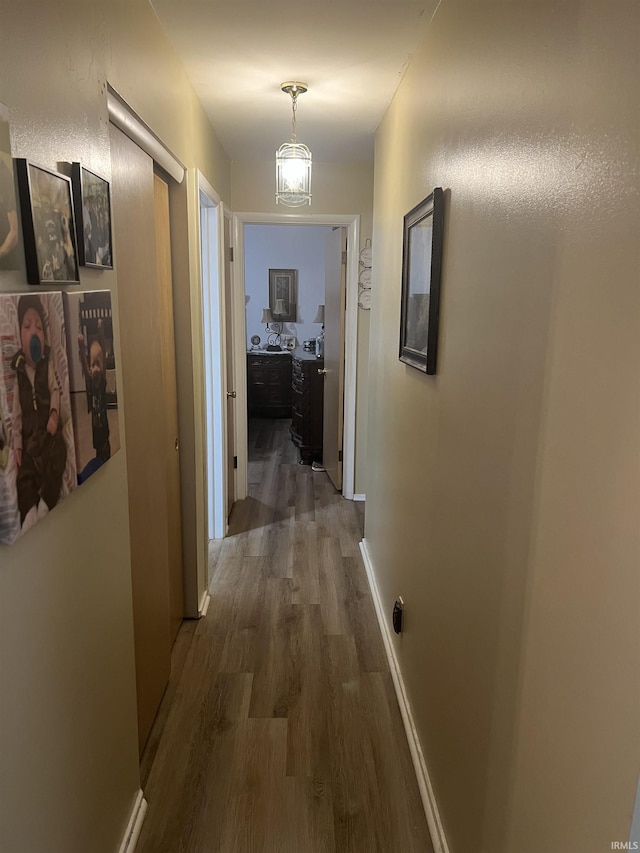 4116 N Lancaster Dr, Muncie, IN 47304 - hall featuring baseboards, an inviting chandelier, and wood finished floors