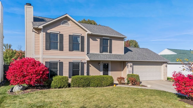 view of property featuring a front yard and a garage