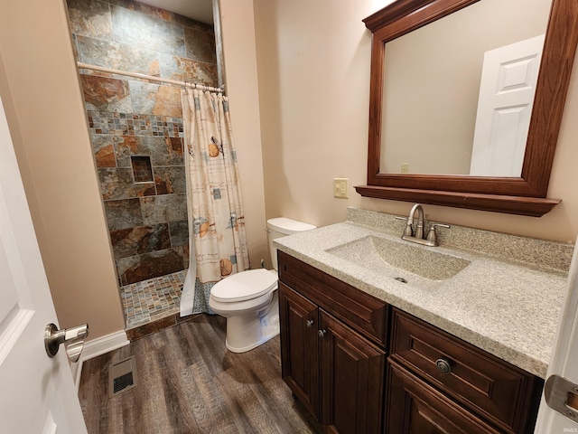 bathroom featuring vanity, toilet, hardwood / wood-style flooring, and a shower with curtain