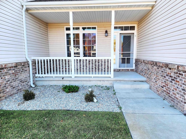 view of exterior entry featuring a porch