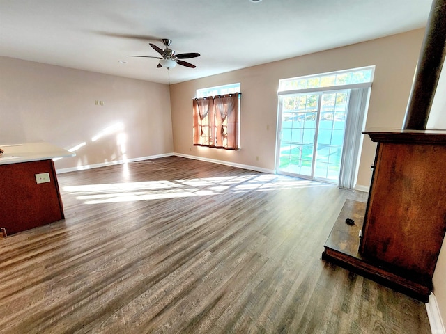 unfurnished living room with ceiling fan and hardwood / wood-style flooring