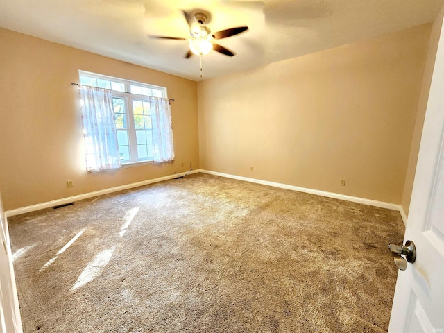 carpeted empty room featuring ceiling fan