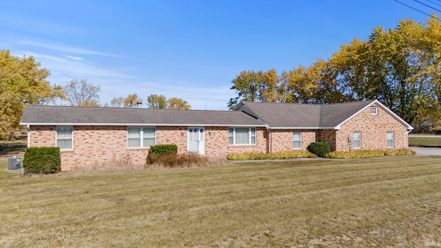 ranch-style home with a front yard and central AC unit