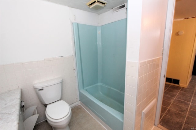 full bathroom featuring vanity, tile patterned flooring, toilet, and tile walls