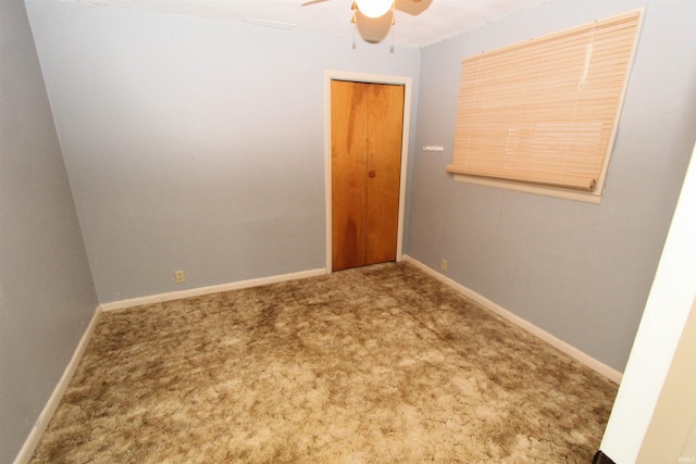 carpeted empty room with ceiling fan