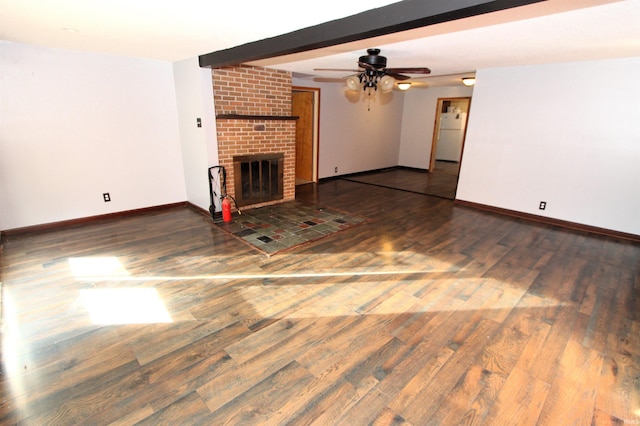 unfurnished living room featuring beam ceiling, ceiling fan, dark hardwood / wood-style floors, and a fireplace