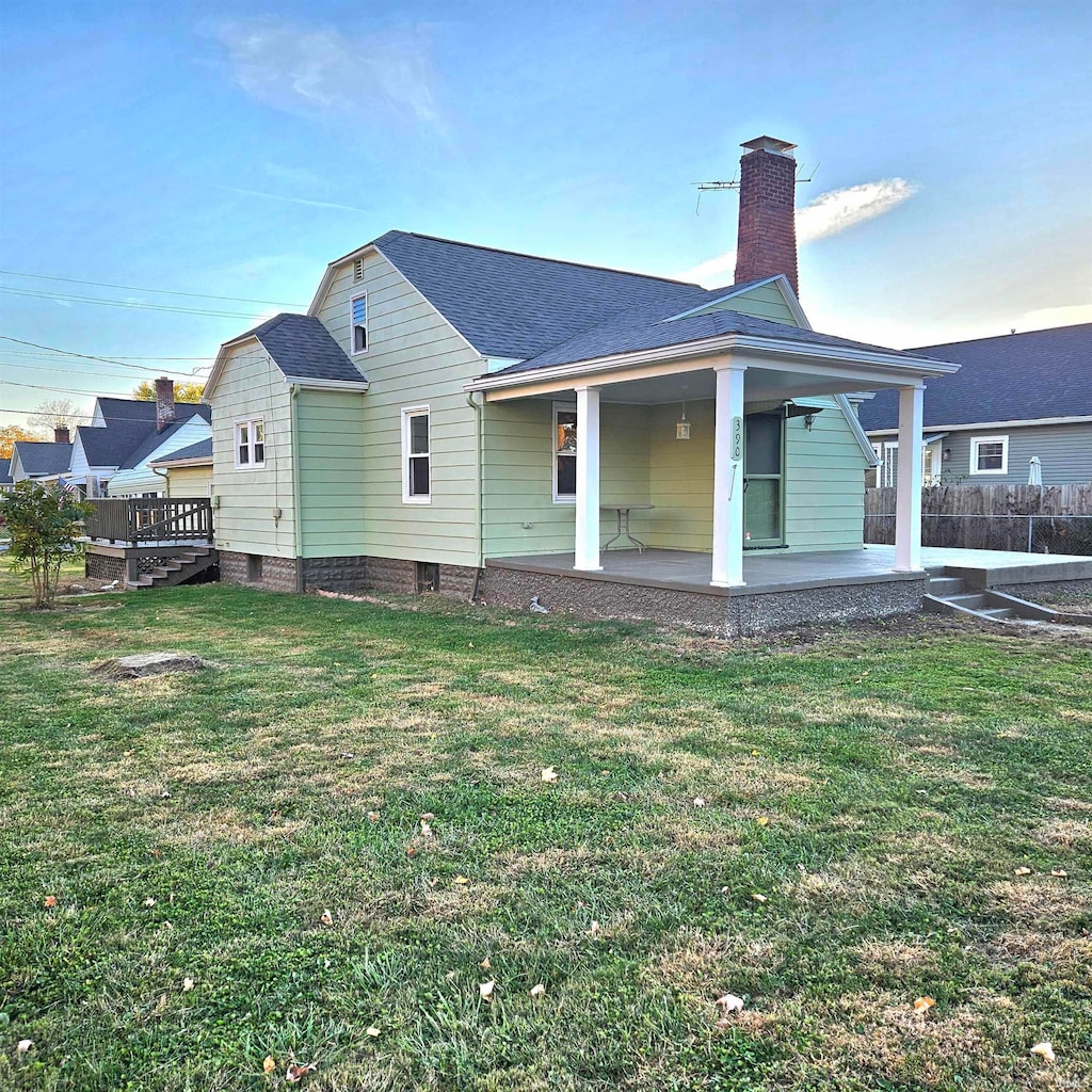 back of house with a yard and a patio area